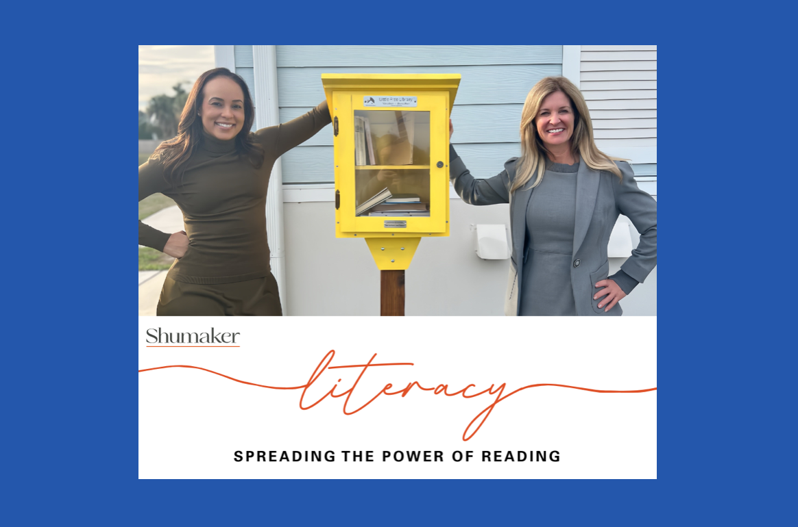 Literacy - Spreading the Power of Reading. Shumaker staff on either side of a Little Library. Image courtesy of Shumaker.